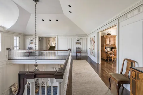 a view of a hallway with furniture and window