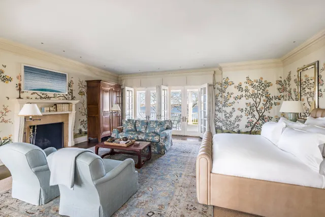 a living room with furniture large window and a fireplace