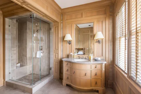 a bathroom with a sink a mirror and a shower