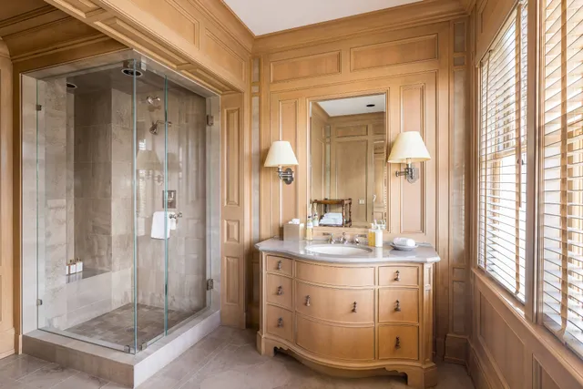 a bathroom with a sink a mirror and a shower