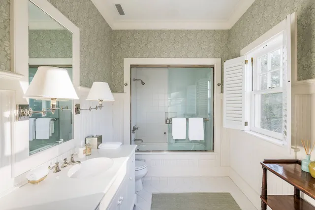 a bathroom with a sink tub and a mirror