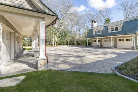 a front view of a house with a garden and yard