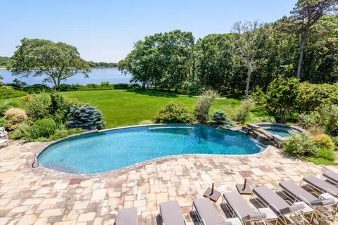 a view of a swimming pool with a yard