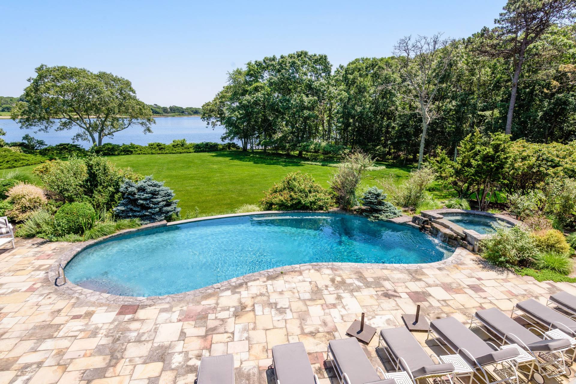 38 Mathews Road Wainscott, NY 11975 - Photo 5 of 48 a view of a swimming pool with a yard