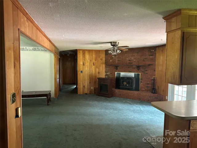 a view of empty room with a fireplace