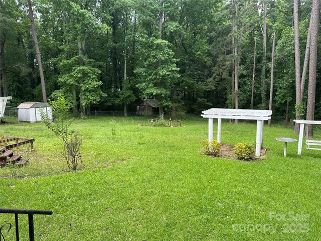 a view of a chair and table in the garden