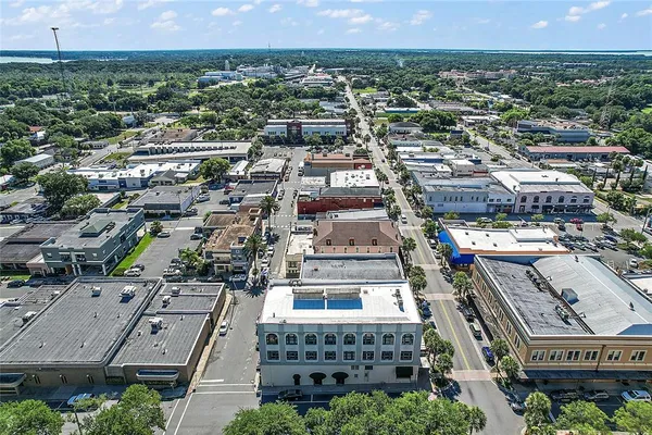 an aerial view of residential houses with city view