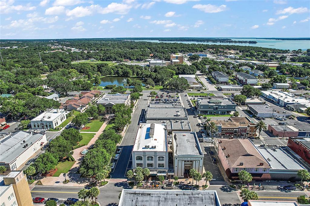 410 West Main Street Leesburg, FL 34748 - Photo 18 of 28 an aerial view of a city with lots of residential buildings ocean and mountain view in back