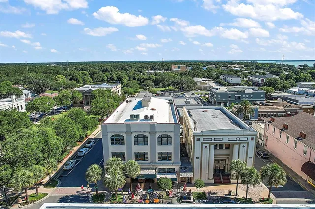 an aerial view of residential houses with outdoor space and street view