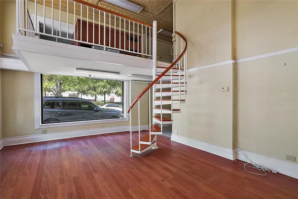 a view of entryway with wooden floor and fence