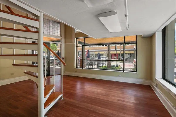 a view of entryway with wooden floor and front door