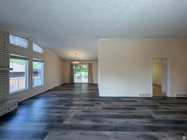 595 Meadowlark Road Orem, UT 84097 - Photo 3 of 87 Spacious interior featuring wood-finish flooring, a white brick fireplace, multiple large windows, and crown molding