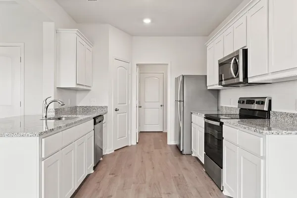 a kitchen with stainless steel appliances granite countertop a sink stove and refrigerator