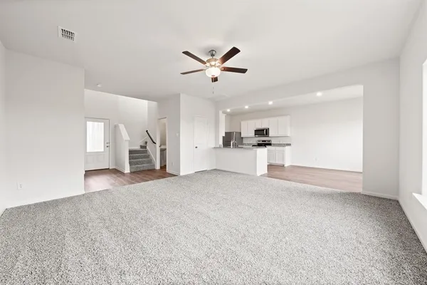 a view of a kitchen with a sink and a refrigerator