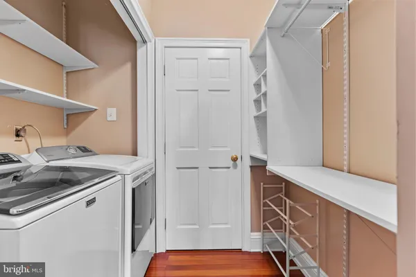 a utility room with cabinets washer and dryer