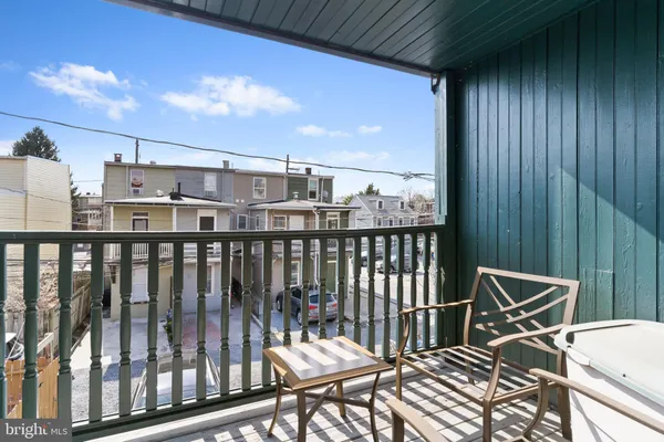 a balcony with table and chairs