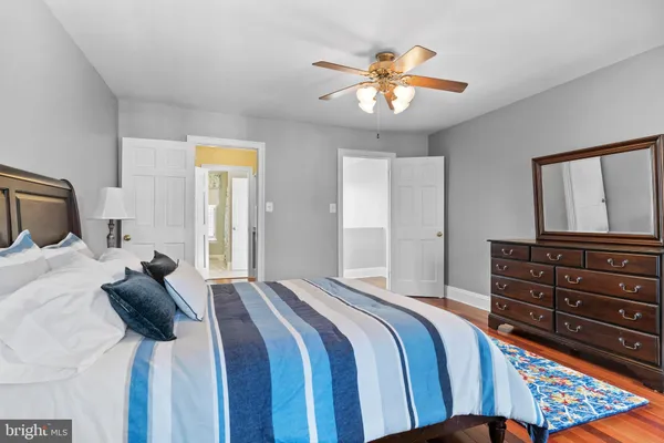a bedroom with a bed and painting on the wall
