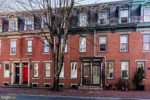 a red brick building that has lots of windows on it