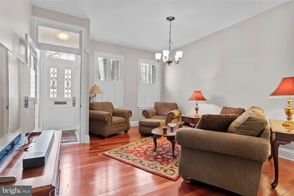 a living room with furniture and a chandelier