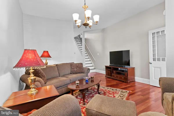 a living room with furniture a flat screen tv and a window