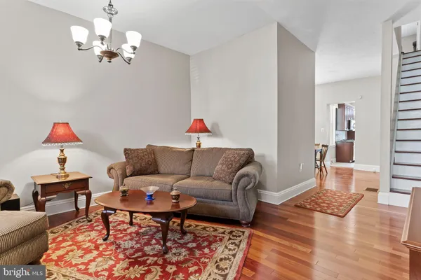 a living room with furniture and a chandelier