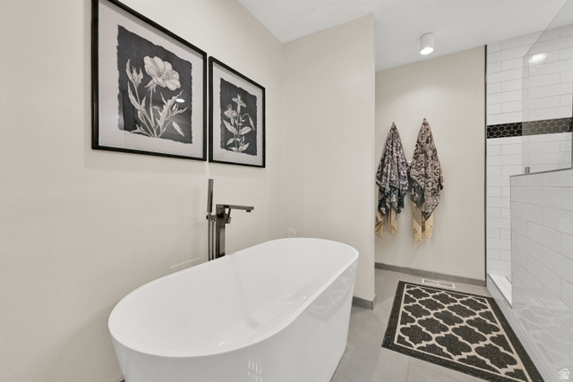 2314 Ridgewood Way Bountiful, UT 84010 - Photo 13 of 26 Freestanding soaking tub with floor-mounted faucet, walk-in shower with subway tile, and a decorative black hexagon tile accent