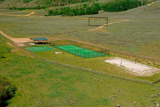 33 North Dry Valley Road, Unit 33 Helper, UT 84526 - Photo 2 of 8 Multi-sport complex featuring a fenced tennis court, a basketball half-court, and a sand volleyball court