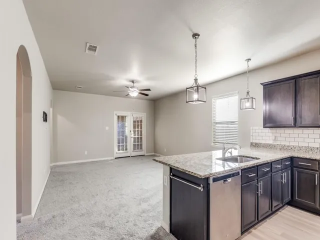 a kitchen with a sink and chandelier
