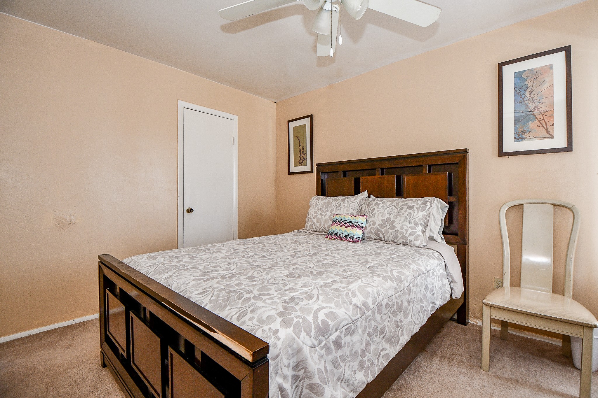 2923 West Greens Road Houston, TX 77067 - Photo 16 of 32 a bedroom with a bed and a chandelier