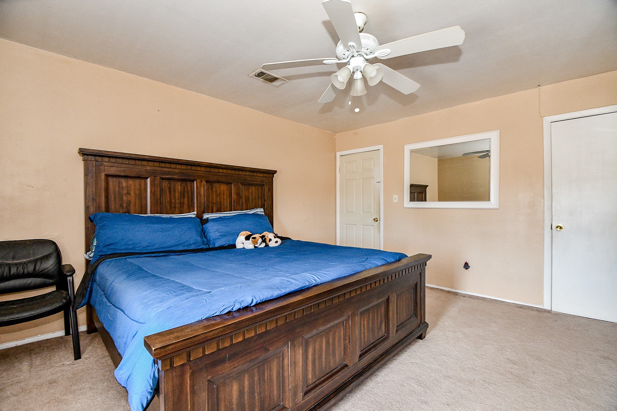 2923 West Greens Road Houston, TX 77067 - Photo 19 of 32 a bed room with a bed and a chandelier