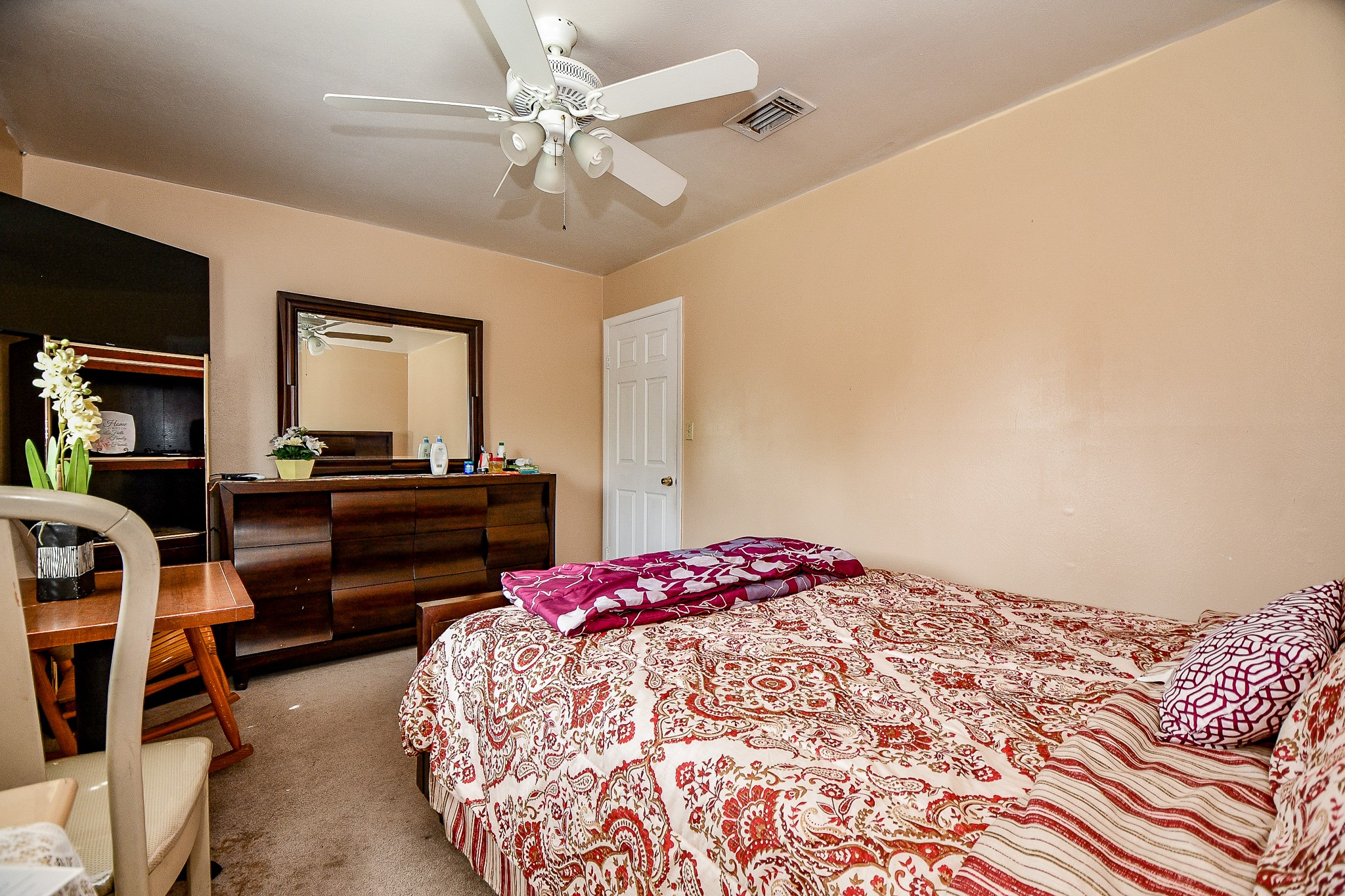 2923 West Greens Road Houston, TX 77067 - Photo 20 of 32 a bedroom with a bed and a chandelier