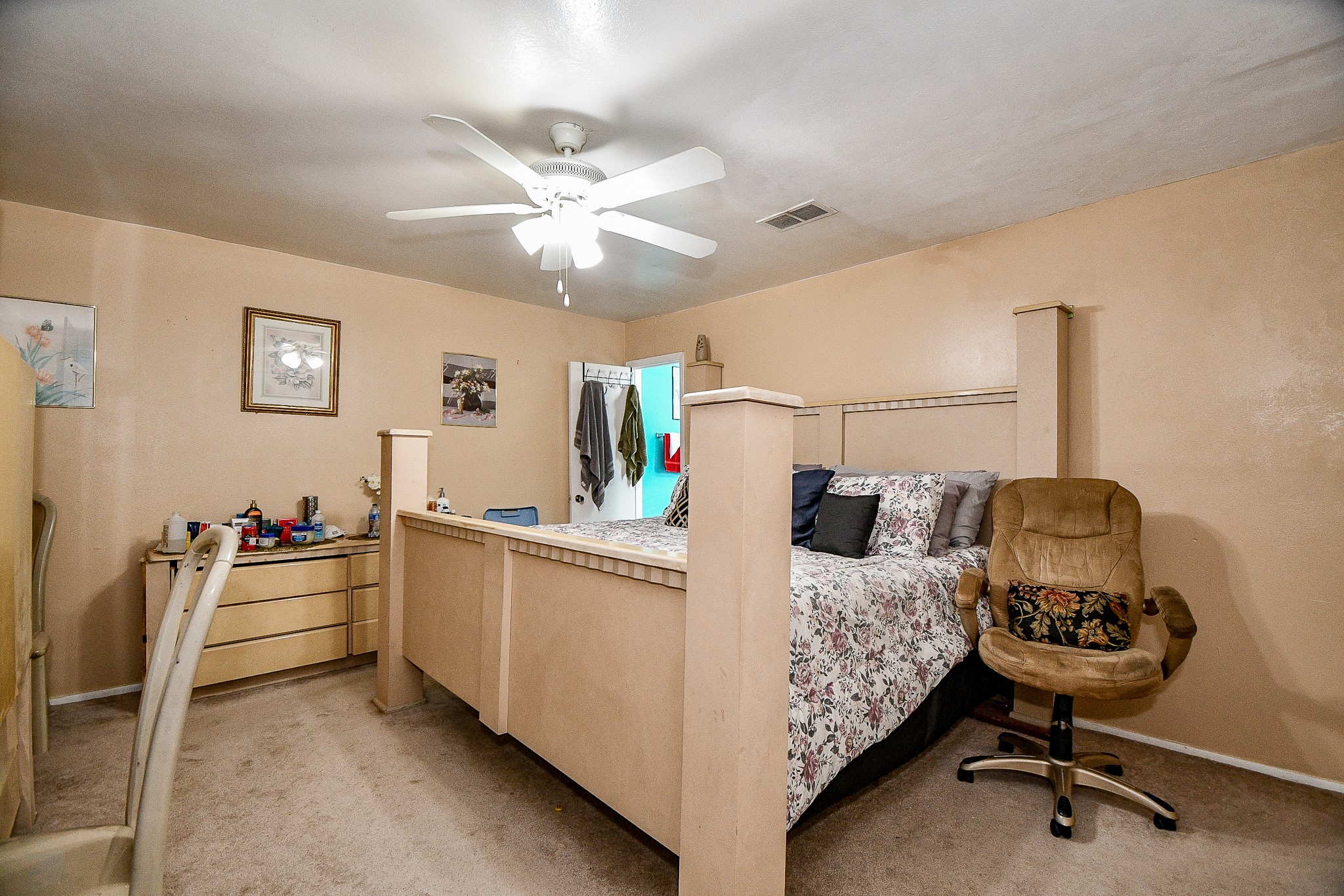 2923 West Greens Road Houston, TX 77067 - Photo 27 of 32 a bedroom with furniture and a chandelier