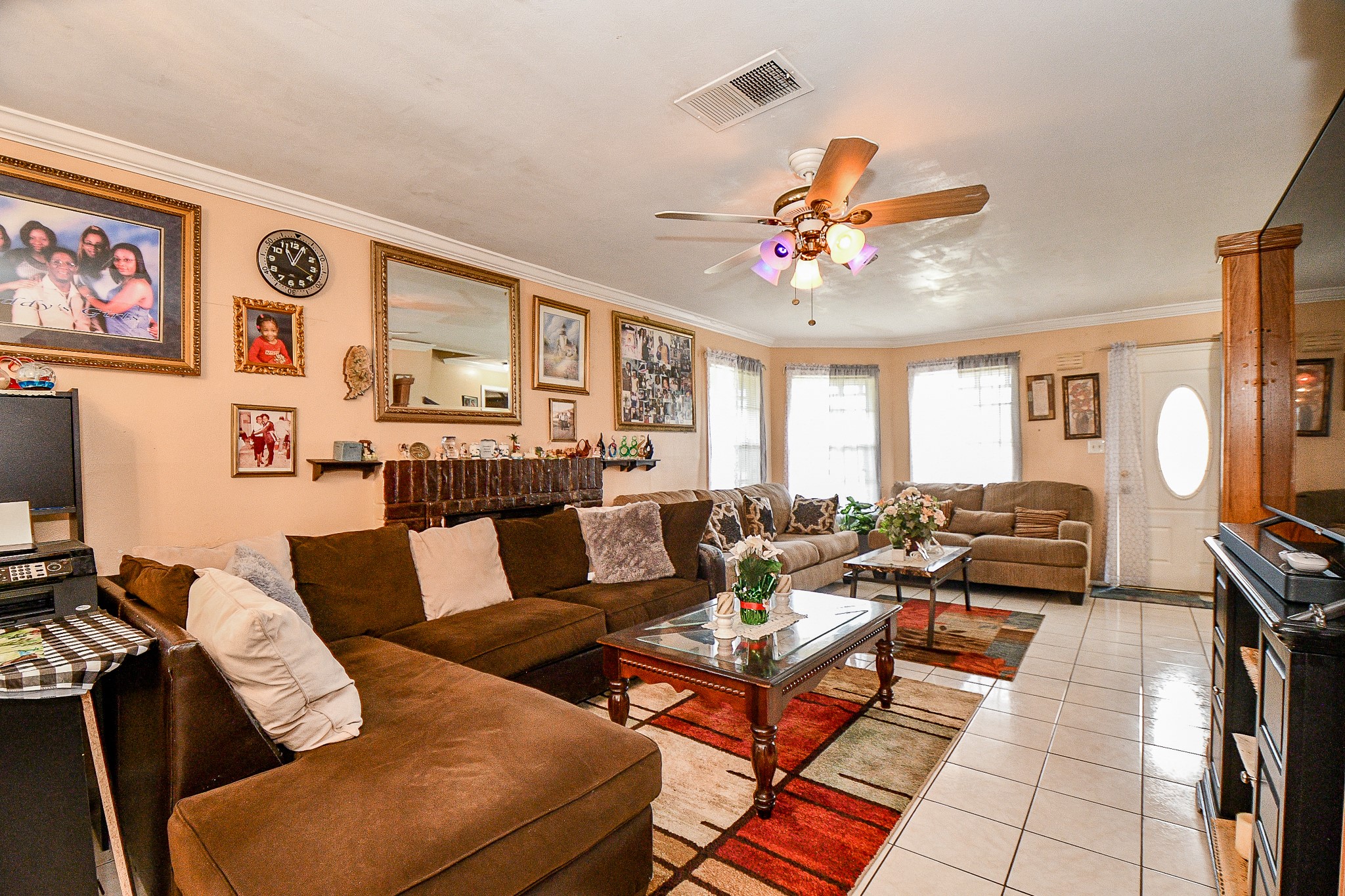 2923 West Greens Road Houston, TX 77067 - Photo 6 of 32 a living room with furniture a couch and a chandelier