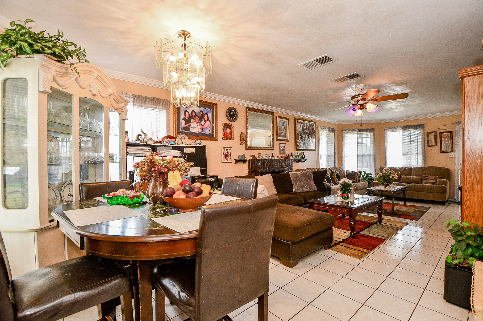 2923 West Greens Road Houston, TX 77067 - Photo 8 of 32 a living room with furniture a chandelier and a dining table