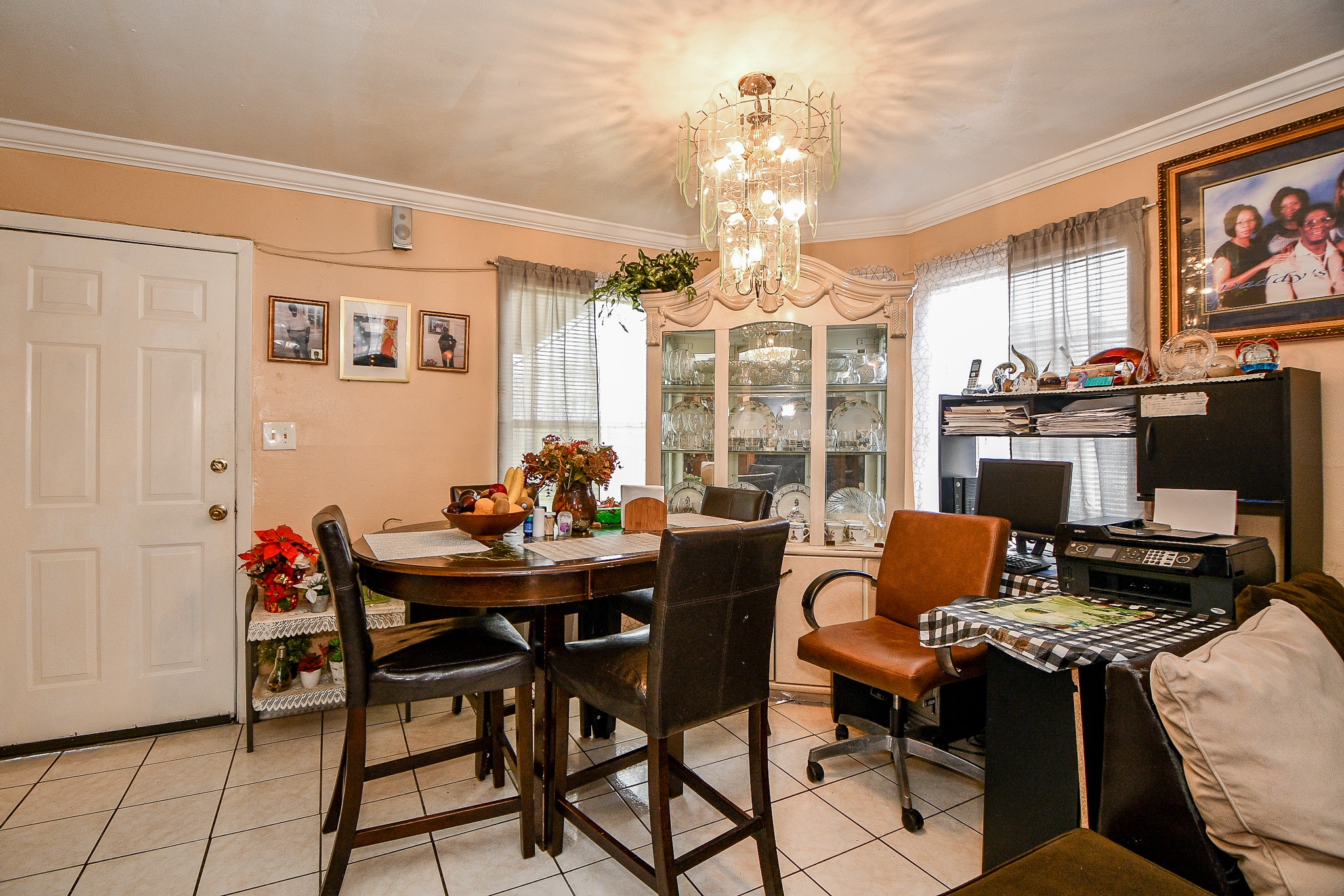 2923 West Greens Road Houston, TX 77067 - Photo 9 of 32 a view of a dining room with furniture a chandelier and wooden floor
