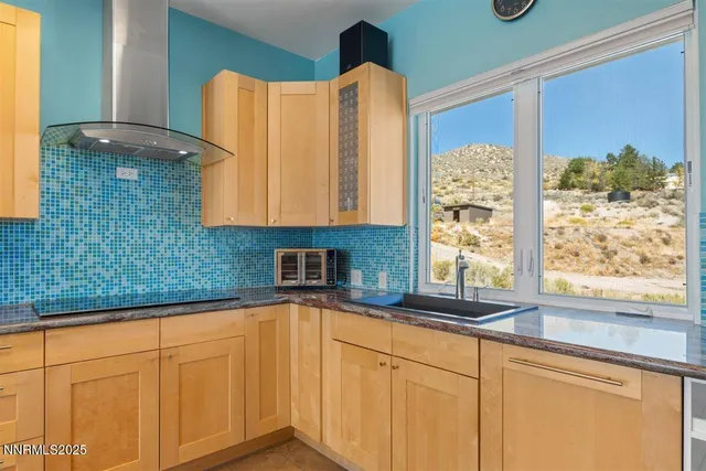 a kitchen with stainless steel appliances a sink and a large window