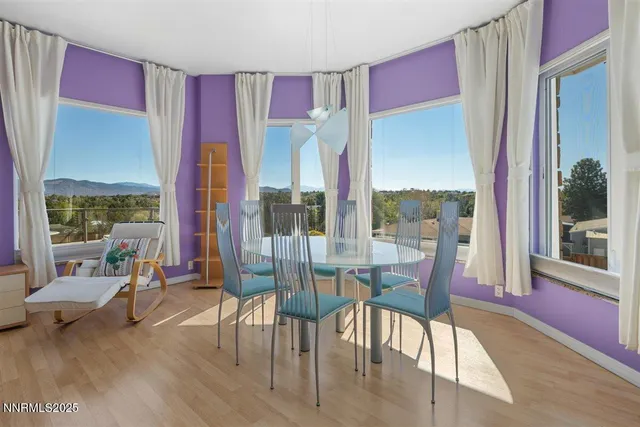 a dining room with furniture water view and large windows