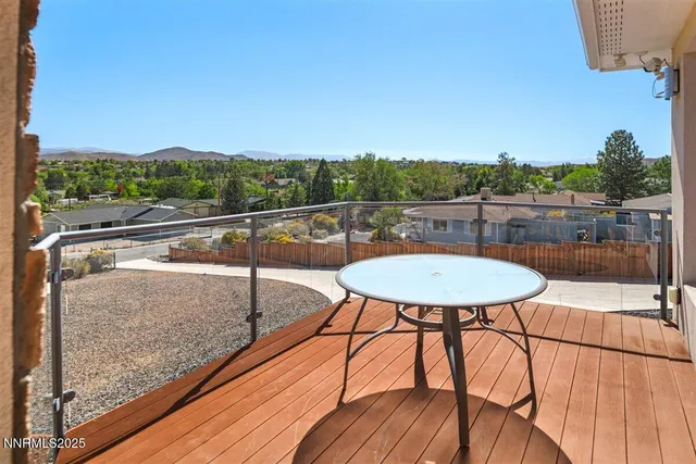 a view of a balcony with a table and chairs