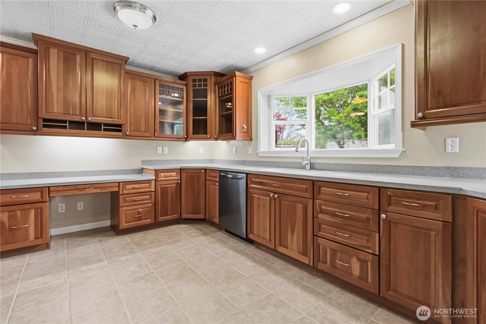 1306 23rd Avenue Longview, WA 98632 - Photo 12 of 40 a kitchen with stainless steel appliances granite countertop wooden cabinets a sink and a window