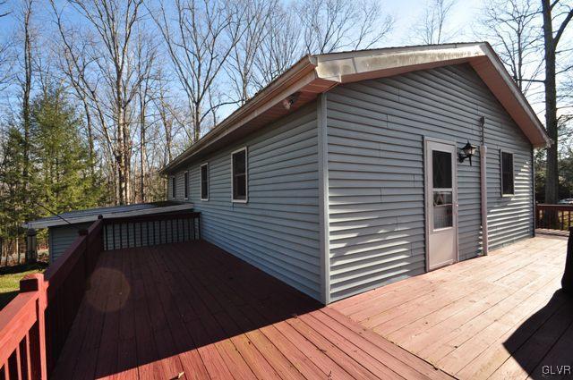 369 Timber Hill Road Henryville, PA 18332 - Photo 18 of 21 a view of a house with a deck