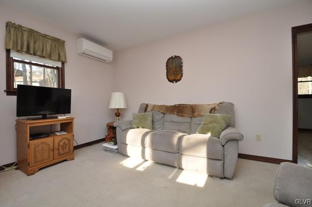 369 Timber Hill Road Henryville, PA 18332 - Photo 5 of 21 a living room with furniture and a flat screen tv