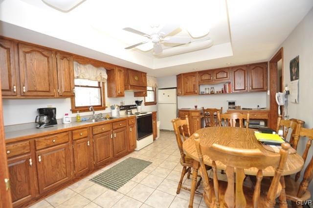 369 Timber Hill Road Henryville, PA 18332 - Photo 9 of 21 a kitchen with stainless steel appliances granite countertop a stove a sink dishwasher and a refrigerator with wooden cabinets