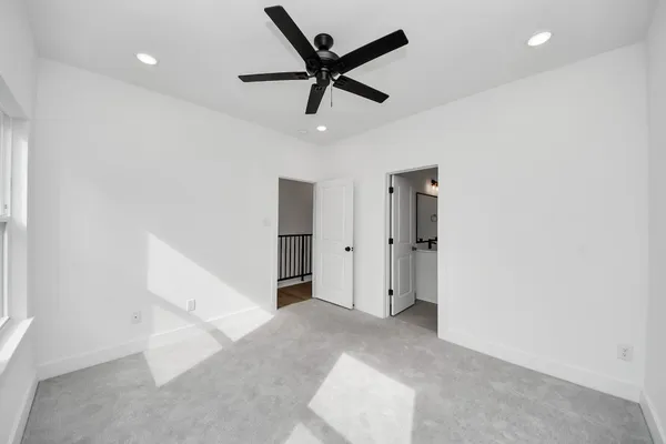 a bathroom with a shower sink mirror and toilet