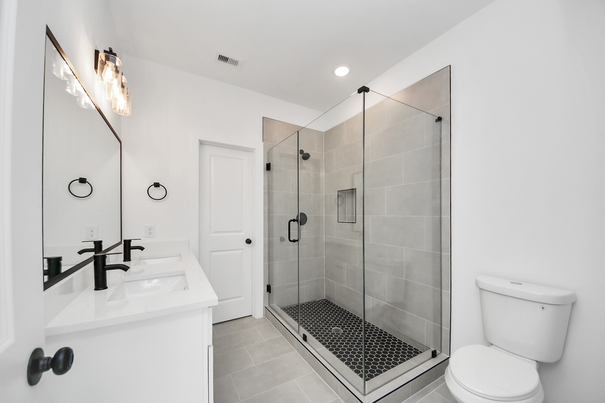 2708 Bostic Street, Unit B Houston, TX 77093 - Photo 13 of 26 a bathroom with a shower sink mirror and toilet