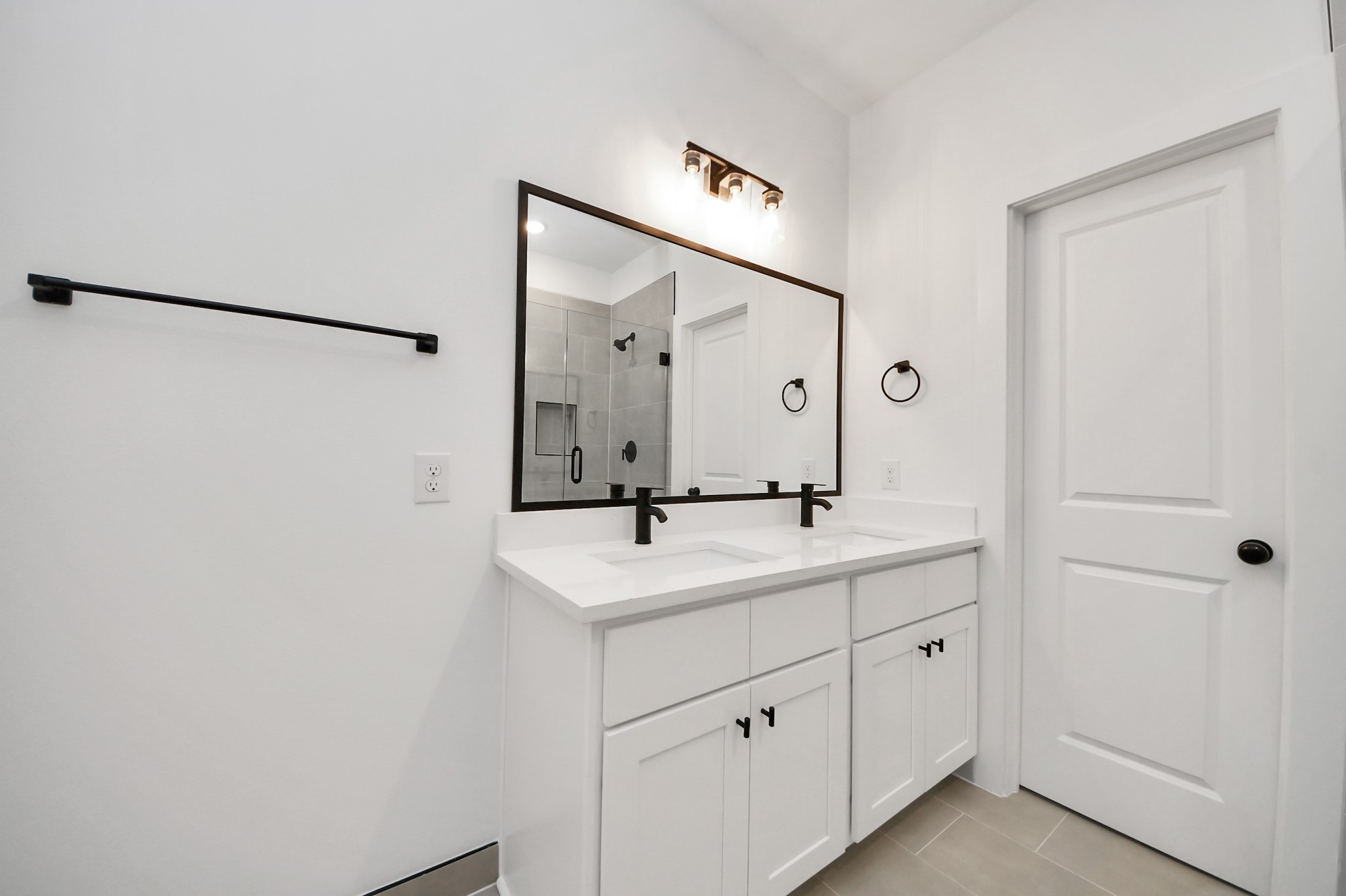2708 Bostic Street, Unit B Houston, TX 77093 - Photo 14 of 26 a bathroom with a double vanity sink a mirror and shower