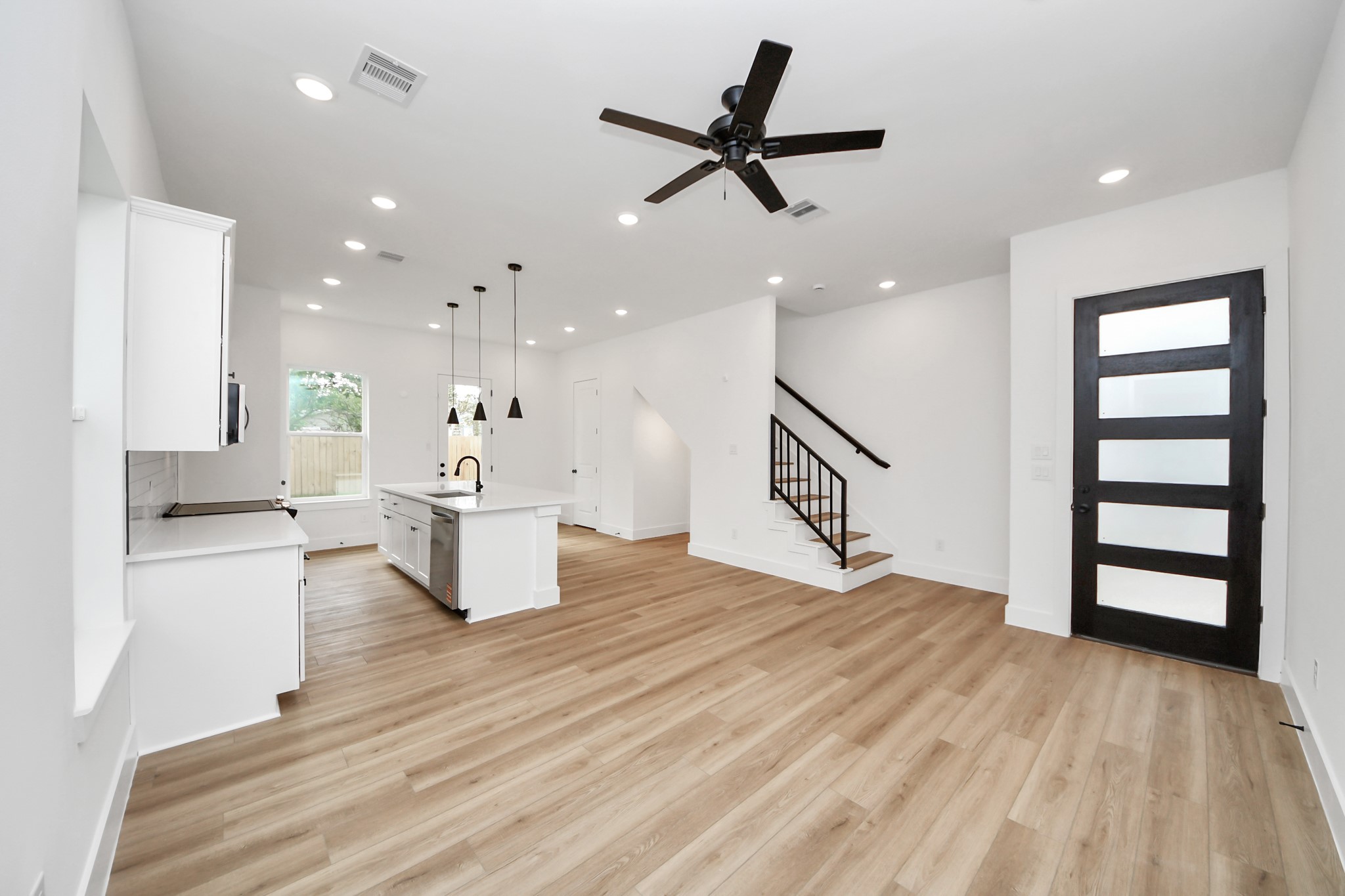 2708 Bostic Street, Unit B Houston, TX 77093 - Photo 2 of 26 a living room with kitchen island furniture and a wooden floor