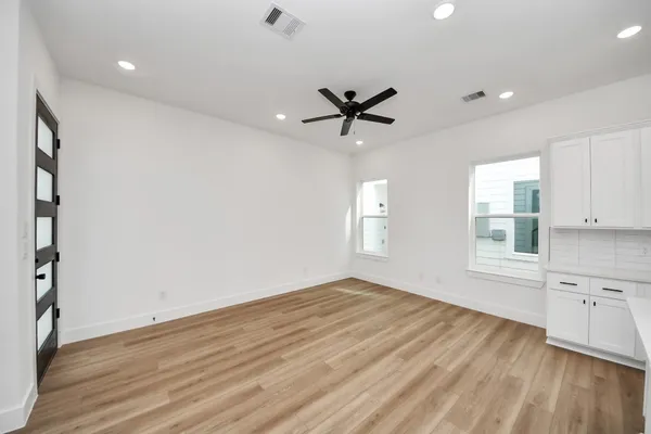 wooden floor in an empty room with a window