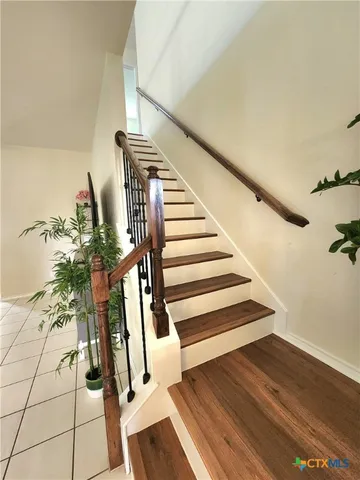 a view of entryway and hall with wooden floor