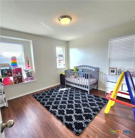 a bedroom with furniture and a window