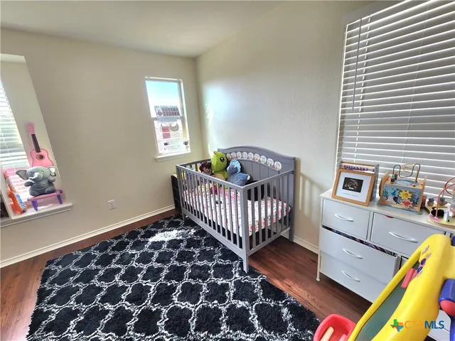 a bedroom with furniture and a window